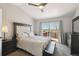 Bedroom with a large bed, sliding door to deck, and neutral-colored walls at 8588 Sweet Clover Way, Parker, CO 80134