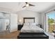 Bedroom with a large bed, sliding door to deck, and neutral-colored walls at 8588 Sweet Clover Way, Parker, CO 80134