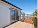 Outdoor deck with wood flooring and railing, accessible through a sliding glass door, offering a private outdoor space at 8588 Sweet Clover Way, Parker, CO 80134