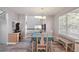 Bright dining area features a modern chandelier, large windows, and a desk area, perfect for meals and work at 8588 Sweet Clover Way, Parker, CO 80134