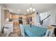 Bright kitchen with wood cabinets, stainless steel appliances, and dining table set at 8588 Sweet Clover Way, Parker, CO 80134