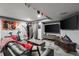 Finished basement with large TV, gray carpet, and exercise equipment for at-home workouts at 15800 E 121St Ave # 4K, Brighton, CO 80603