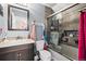 Stylish bathroom features wood-look tile, updated fixtures, vanity, and shower at 15800 E 121St Ave # 4K, Brighton, CO 80603