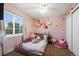 Whimsical bedroom features a large window, plush accents, and a walk-in closet at 15800 E 121St Ave # 4K, Brighton, CO 80603