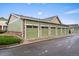 Row of individual garages with green doors and stone accents at 15800 E 121St Ave # 4K, Brighton, CO 80603