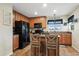 Well-lit kitchen featuring an island with seating and stainless steel appliances at 15800 E 121St Ave # 4K, Brighton, CO 80603