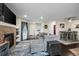 Open-concept living room and dining area with fireplace and hardwood floors at 15800 E 121St Ave # 4K, Brighton, CO 80603