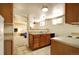 Small, functional basement kitchen with wood cabinets and appliances at 35 S Washington St # 1-2, Denver, CO 80209