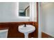 Bathroom with pedestal sink, wood accents, and modern fixtures at 35 S Washington St # 1-2, Denver, CO 80209