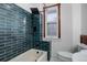 Modern bathroom with teal tile shower/tub combo at 35 S Washington St # 1-2, Denver, CO 80209