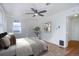 Bedroom with hardwood floors, ceiling fan, and access to hallway at 35 S Washington St # 1-2, Denver, CO 80209