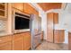 Kitchen with wood cabinets, granite counters, and stainless steel appliances at 35 S Washington St # 1-2, Denver, CO 80209