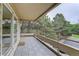 Balcony with grey tiled flooring and sliding door, with tree-filled views at 4605 S Yosemite St # 301, Denver, CO 80237