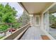 Balcony with grey tiled flooring and sliding door, overlooking lush greenery at 4605 S Yosemite St # 301, Denver, CO 80237