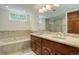 Elegant bathroom featuring a double vanity, soaking tub, and glass-enclosed shower at 4605 S Yosemite St # 301, Denver, CO 80237