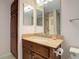 Bathroom featuring granite countertop vanity and wooden storage cabinet at 4605 S Yosemite St # 301, Denver, CO 80237