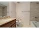 Bathroom featuring granite countertop vanity, tile shower, and toilet at 4605 S Yosemite St # 301, Denver, CO 80237