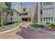 Building exterior showcasing a stone walkway, lush landscaping, and multiple windows at 4605 S Yosemite St # 301, Denver, CO 80237