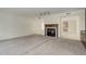 Carpeted living room featuring a fireplace with a wooden mantel and built-in cabinetry at 4605 S Yosemite St # 301, Denver, CO 80237