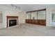 Carpeted living room featuring a fireplace, wooden mantel, and built-in shelving at 4605 S Yosemite St # 301, Denver, CO 80237