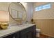 Bathroom with a marble countertop, modern fixtures, stylish wallpaper, and gold accents at 10828 Valleybrook Cir, Highlands Ranch, CO 80130