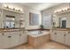 Elegant bathroom featuring a soaking tub, dual vanities, and stylish tile work at 10828 Valleybrook Cir, Highlands Ranch, CO 80130