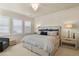 Bright bedroom featuring a queen bed, matching nightstands, a decorative lamp, and shuttered windows at 10828 Valleybrook Cir, Highlands Ranch, CO 80130