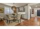 Dining area featuring a circular table, a large pendant light, and built-in white cabinets with a wine cooler at 10828 Valleybrook Cir, Highlands Ranch, CO 80130