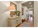 Inviting entryway with carved cabinet and ornate mirror, offering a glimpse into the home's open floor plan at 10828 Valleybrook Cir, Highlands Ranch, CO 80130