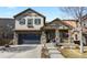 Charming two-story home with stone accents, inviting front porch, and well-manicured landscaping, creating excellent curb appeal at 10828 Valleybrook Cir, Highlands Ranch, CO 80130