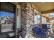 Charming front porch with brick facade, comfortable seating, and a welcoming entrance at 10828 Valleybrook Cir, Highlands Ranch, CO 80130