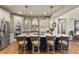 Modern kitchen with stainless steel appliances, a large center island, and stylish pendant lighting for a seamless cooking experience at 10828 Valleybrook Cir, Highlands Ranch, CO 80130