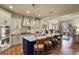 Bright and airy kitchen featuring an island with bar seating, stainless steel appliances, and easy access to the living spaces at 10828 Valleybrook Cir, Highlands Ranch, CO 80130