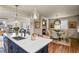 Open kitchen with a large island and bar stool seating leading to a cozy dining area and a fireplace at 10828 Valleybrook Cir, Highlands Ranch, CO 80130