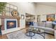 Open living room with fireplace, with seamless flow into the kitchen for easy entertainment and everyday living at 10828 Valleybrook Cir, Highlands Ranch, CO 80130