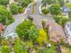 Aerial view of a tree-lined neighborhood showcasing mature landscaping and well-maintained lawns at 12193 Deerfield Way, Broomfield, CO 80020