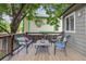 Comfortable back deck featuring outdoor seating with a view of lush landscaping and mature trees at 12193 Deerfield Way, Broomfield, CO 80020