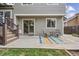 Back patio with outdoor seating, colorful rug, stairs to deck, and sliding glass doors into the home at 12193 Deerfield Way, Broomfield, CO 80020