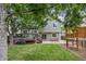 Large backyard features a multilevel deck, patio seating, and a playhouse at 12193 Deerfield Way, Broomfield, CO 80020