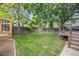 Spacious backyard featuring a well-maintained lawn, mature trees, and multi-level deck at 12193 Deerfield Way, Broomfield, CO 80020
