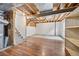Unfinished basement featuring hardwood floors, painted walls, and exposed beams at 12193 Deerfield Way, Broomfield, CO 80020