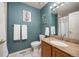 Bright bathroom featuring a granite vanity top, neutral tile, and a decorative piece of artwork at 12193 Deerfield Way, Broomfield, CO 80020