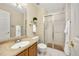 Clean bathroom featuring a glass-enclosed shower, wood vanity, and well-lit mirror at 12193 Deerfield Way, Broomfield, CO 80020