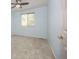 Bright bedroom with light blue walls, a ceiling fan, and a large window at 12193 Deerfield Way, Broomfield, CO 80020