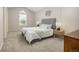 Serene bedroom featuring a neutral color scheme, arched window, and a comfortable queen bed at 12193 Deerfield Way, Broomfield, CO 80020