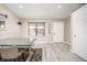Dining room featuring wood floors, a large window and a modern light fixture at 12193 Deerfield Way, Broomfield, CO 80020