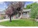 Inviting front entrance with brick accents, flowers, and a cozy porch at 12193 Deerfield Way, Broomfield, CO 80020