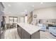 Spacious open-concept kitchen featuring a large island with white countertop and modern lighting at 12193 Deerfield Way, Broomfield, CO 80020