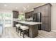 Modern kitchen with gray cabinets, a center island, and stainless steel appliances at 12193 Deerfield Way, Broomfield, CO 80020