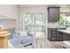 Cozy living area featuring a walkout deck area and stylish gray cabinets and shelving at 12193 Deerfield Way, Broomfield, CO 80020